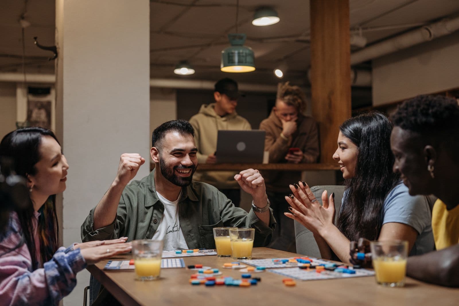 Adults gathered around a table playing a tabletop game